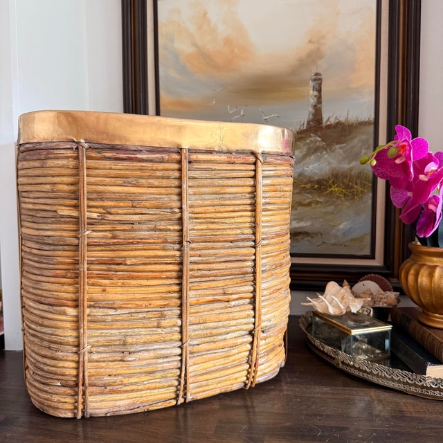 A striking oversized vintage rattan basket in the style of Gabriella Crespi, featuring a sculptural rounded square form...