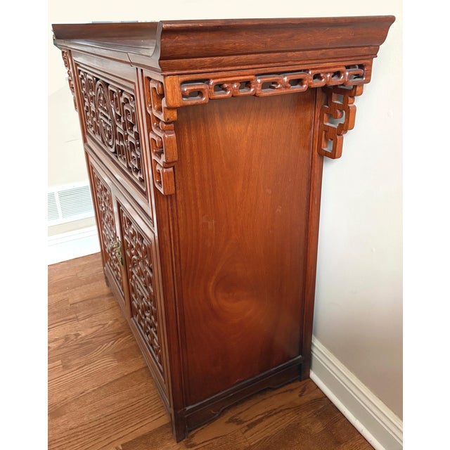 Chinese Carved Hardwood Cabinet Hong Kong This Chinese export cabinet, handcrafted in Hong Kong in the 1960s, reflects...