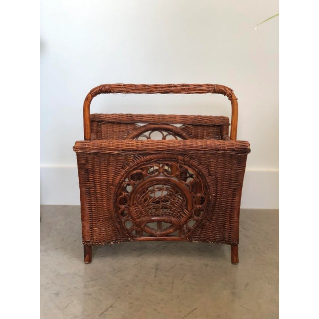 A 1970 woven wicker and bamboo piece. Beautiful craftsmanship from the wicker wrapped handle down to the metal button...