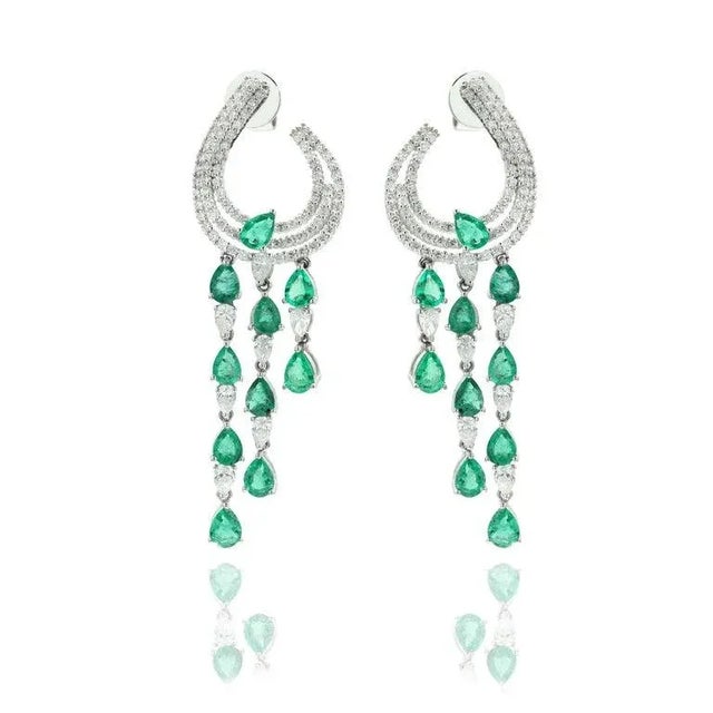 This is part of Chairish’s Fine Jewelry assortment. Emerald and Diamond Dangle Earrings to make a statement with your...