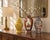 A colorful trio of decorative ceramic vessels featuring complementary floral patterns and graceful silhouettes. The...
