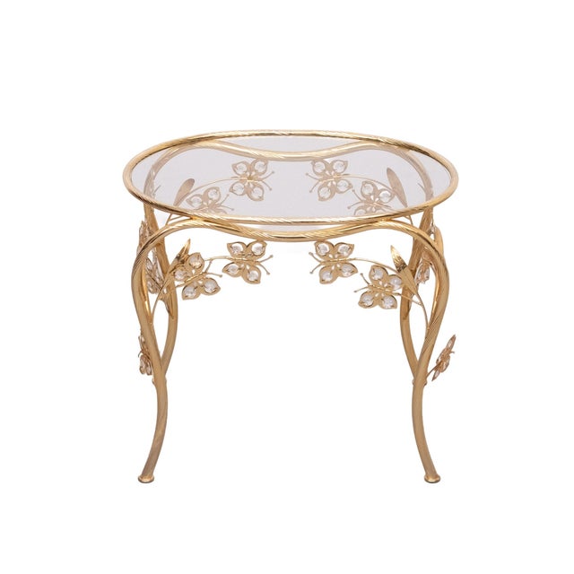 Beautiful Butterfly brass and Chrystal glass side tables . oval shaped , Glass top . Hollywood Regency style . 1980s Italy .
