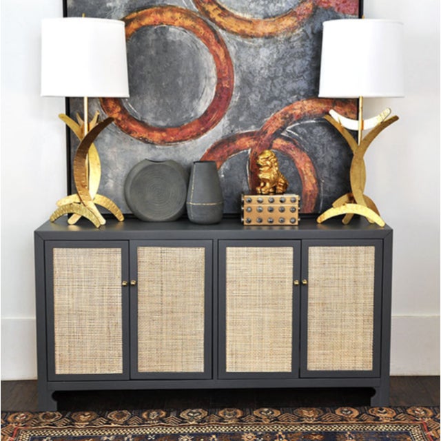 New special order item. Not vintage. British West Indies style with a modern flair, this chic cabinet showcases natural,...