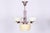 This 4-arm chandelier is a masterpiece of 1920s czechoslovak art deco. The lighting fixture presents a fascinating...