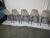 Midcentury white bucket chairs with black legs. Label reads "Herman Miller Furniture Company Zeeland, Michigan". The...