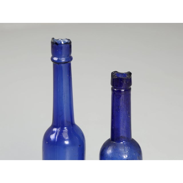 Glass Collection of '15' Cobalt Blue Caster Oil Hand Blown Bottles Made in 1800s For Sale - Image 7 of 12