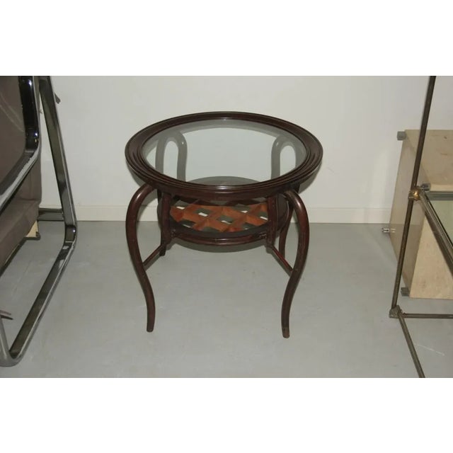 Round table in light and dark wood manufactured in the 1950s.