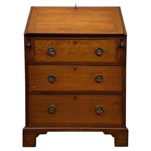 A beautifully crafted early 20th-century English Edwardian bureau, finely constructed in golden oak and combining an...