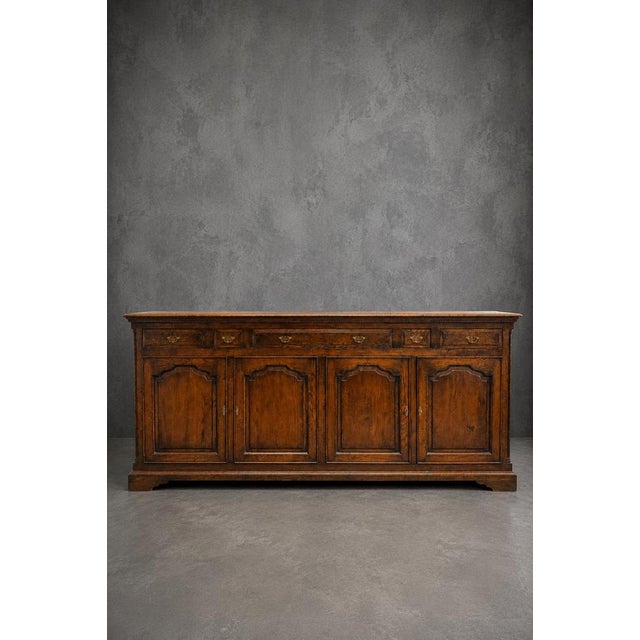 A magnificent Old New England-style oak sideboard, combining generous storage capacity with timeless craftsmanship....