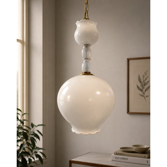 Pendant lamp with an elegant and minimalist design, featuring a large pearly white etched glass diffuser with a soft,...