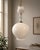 Pendant lamp with an elegant and minimalist design, featuring a large pearly white etched glass diffuser with a soft,...