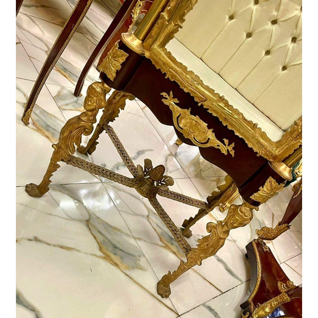 This magnificent French Louis XVI style vitrine showcases exceptional craftsmanship with its richly carved gold leaf...