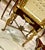 This magnificent French Louis XVI style vitrine showcases exceptional craftsmanship with its richly carved gold leaf...