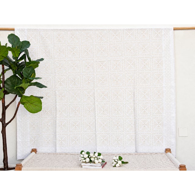 A lightweight cotton coverlet from Western India, beautifully adorned with intricate handcrafted appliqué cutwork. The...