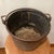 This Antique Copper Cauldron with an Iron Handle is a handmade piece with a rich patina, adding to its charm and...