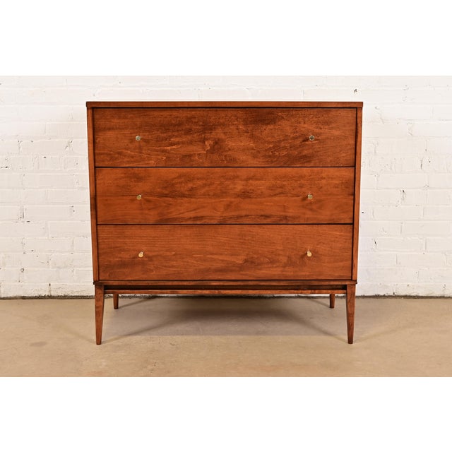 A sleek and stylish Mid-Century Modern three-drawer dresser or chest of drawers By Paul McCobb for Winchendon Furniture,...
