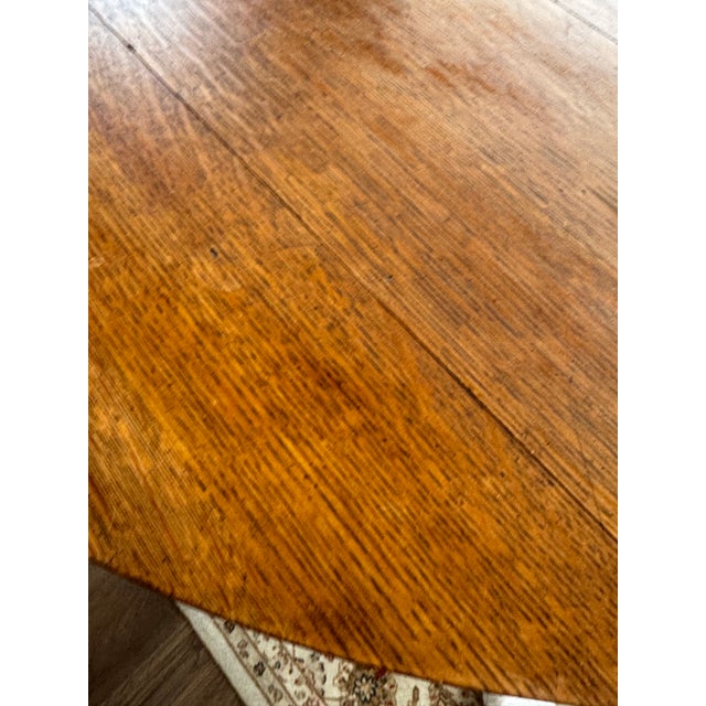 Antique Oak Round Pedestal Table with hand-carved claw feet. Additional intricate carvings on the legs. Table is crafted...