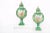Pair gilt porcelain Dresden covered decorative urns / pieces with exterior painted scene design details. Each urn is in...