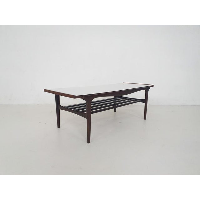 Coffee table with one one side a wooden top and the other side a white formica top. In good condition. The woodne table...