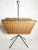 French magazine rack dating from the 1950s, combining woven rattan with a black metal structure and brass details. The...