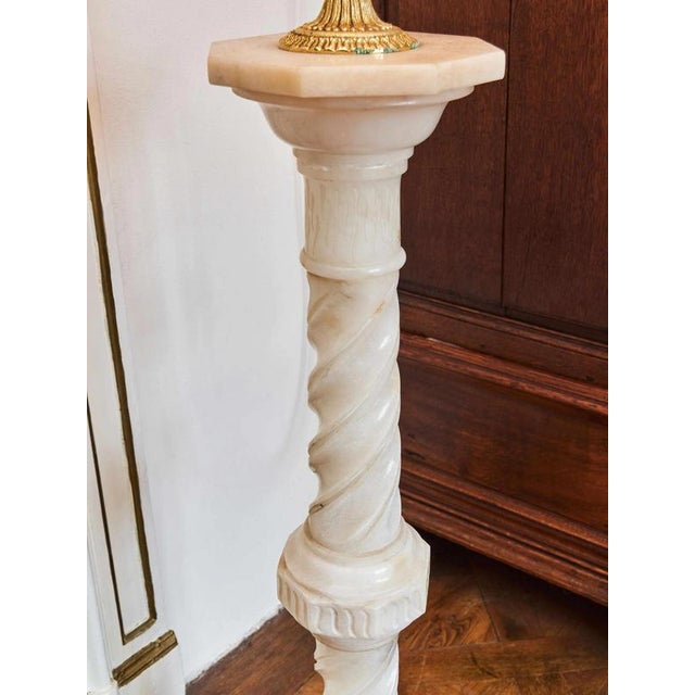 Elegant pedestal made of finely crafted alabaster, dating back to the mid-20th century. The column is richly profiled with...