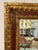 Classic antique Italian rectangular mirror having carved gilded wood frame with red underpaint and old world decoration.