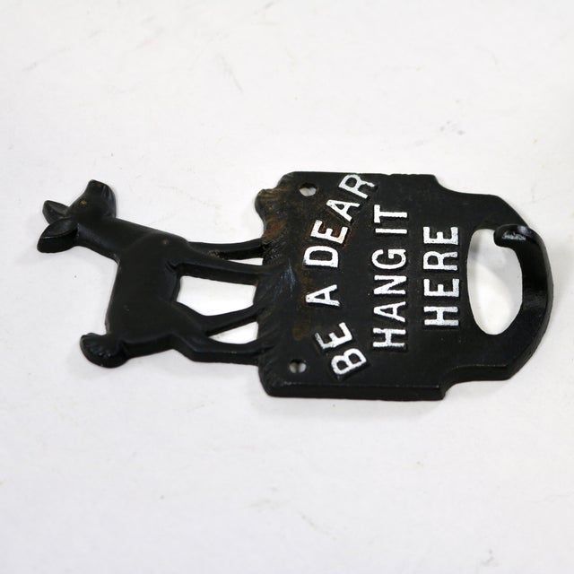 Adorable cast iron hook of a deer standing on a block that states "Be A Dear Hang It Here". I love the deer and the...
