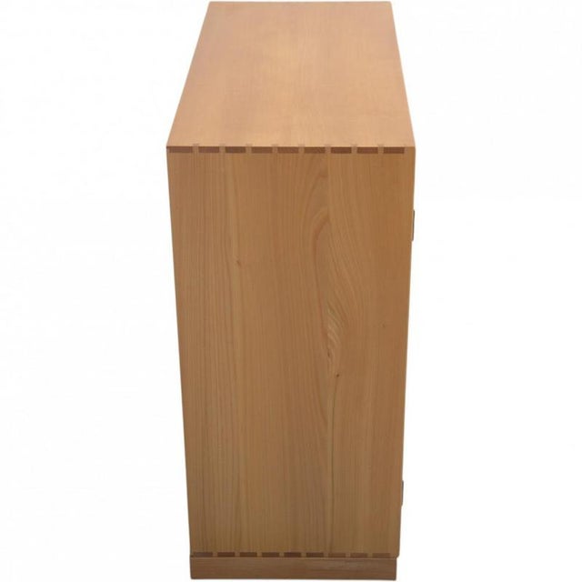 Mogens Koch cabinet made of elm, and from the 1970s. The cabinet appears in good condition with a few marks and scratches....