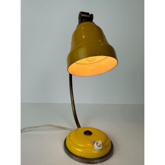 Rare Stilnovo table lamp. Completely original. Mustard yellow color. Brass details. Push switch in the base. Adjustable...