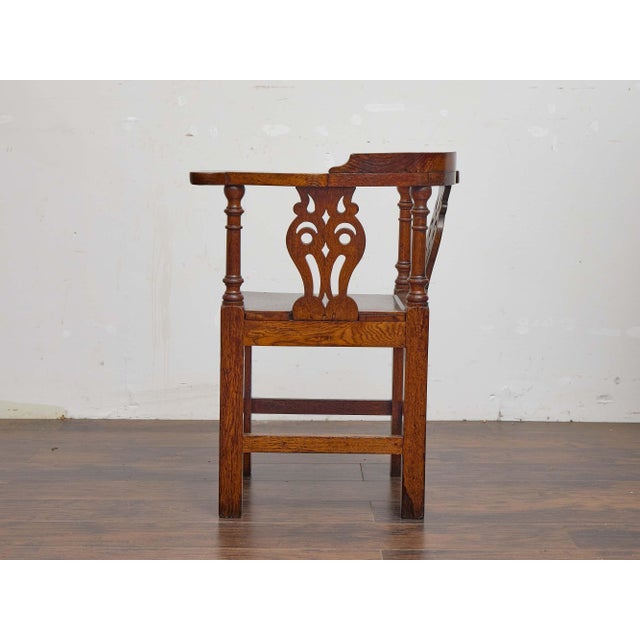 An English oak corner chair from the 19th century, distinguished by its sculptural form and traditional craftsmanship....