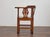 An English oak corner chair from the 19th century, distinguished by its sculptural form and traditional craftsmanship....