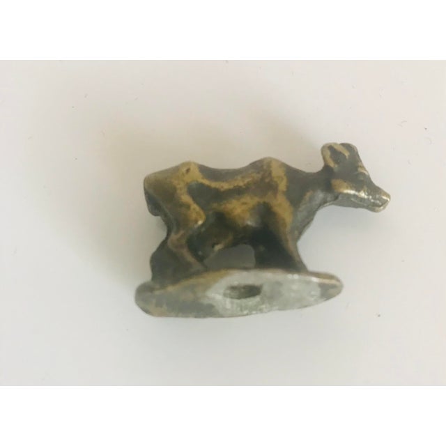 Antique Ancient bronze miniature sculpture of a cow. Netsuke collectible.