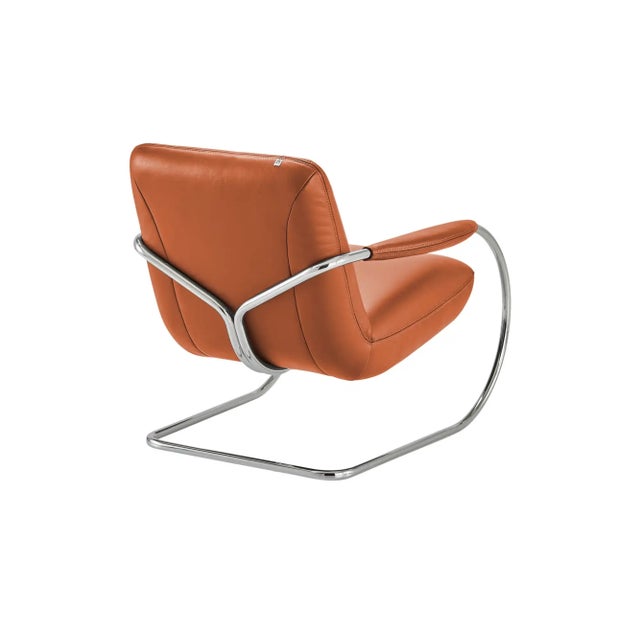 German Interior Innovation award winner from 2013, this dynamic armchair made by Koinor has a cantilevered seat on a honed...