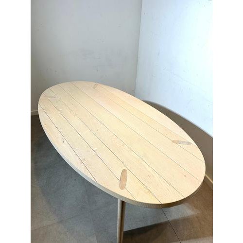 A beautifully crafted dining table by pascal naessens, known for her timeless and organic design approach. This piece...