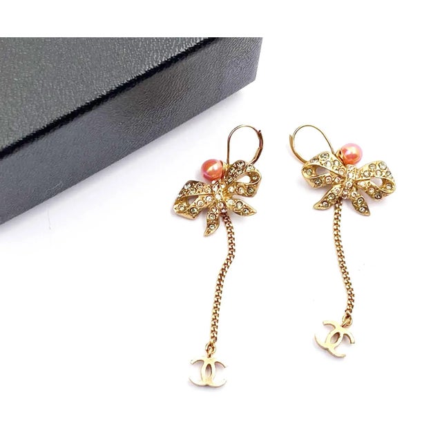 Chanel Vintage Gold Plated Ribbon Crystal Coral CC Dangle Lever Back Earrings *Marked 03 *Made in France *Comes with...