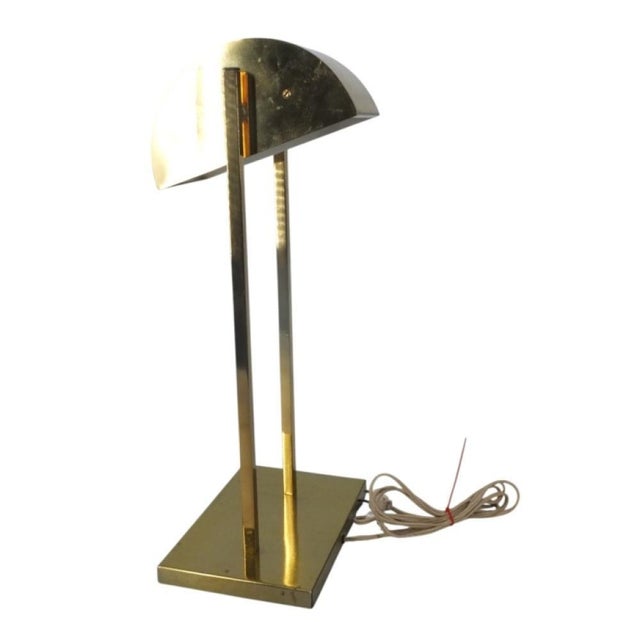 1970's Kovacs for Koch and Lowy brass desk top table lamp with an adjustible brass demilune shade. The shade is supported...