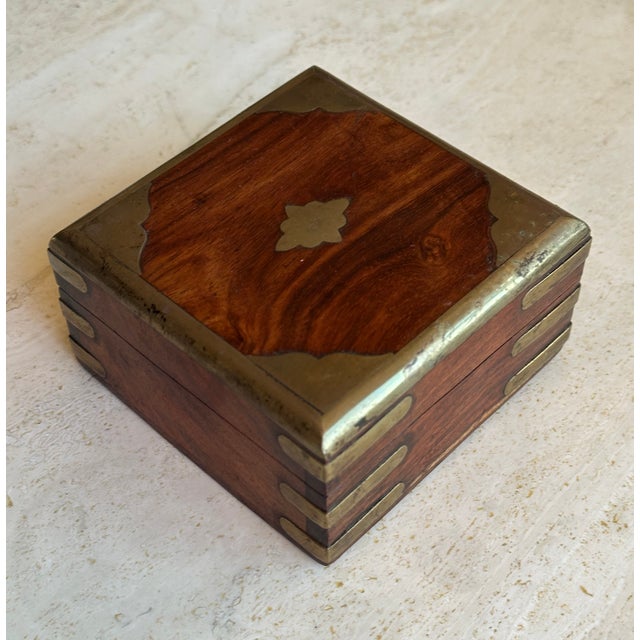This refined antique Anglo-Indian wooden box features solid hardwood construction with brass corner mounts, edge banding,...