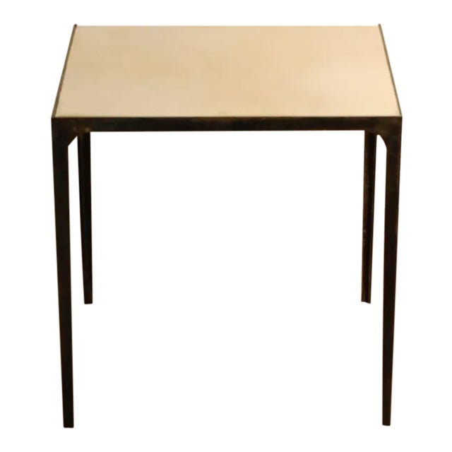 Pair of 'Esquisse' parchment and blackened wrought iron side tables by Design Frères. The smooth, natural cream parchment...