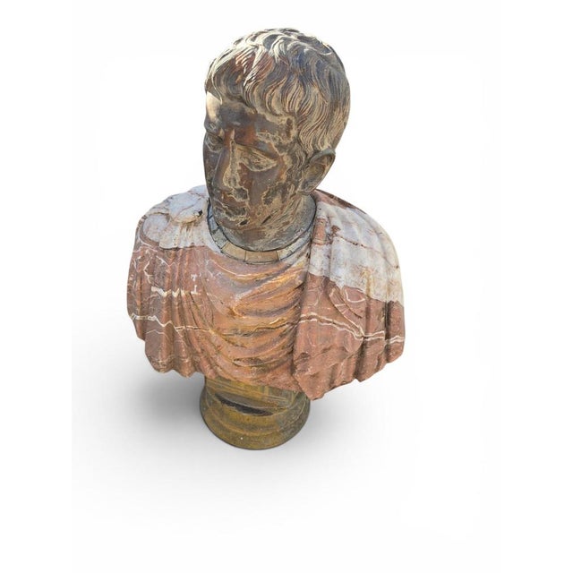 Impressive bust depicting a Roman emperor, masterfully crafted from a combination of colored marbles during the first half...
