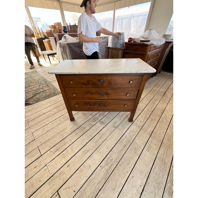 19th Century French Neoclassic Commode from France. Made of walnut, with a withe marble top, the wood has been finished...