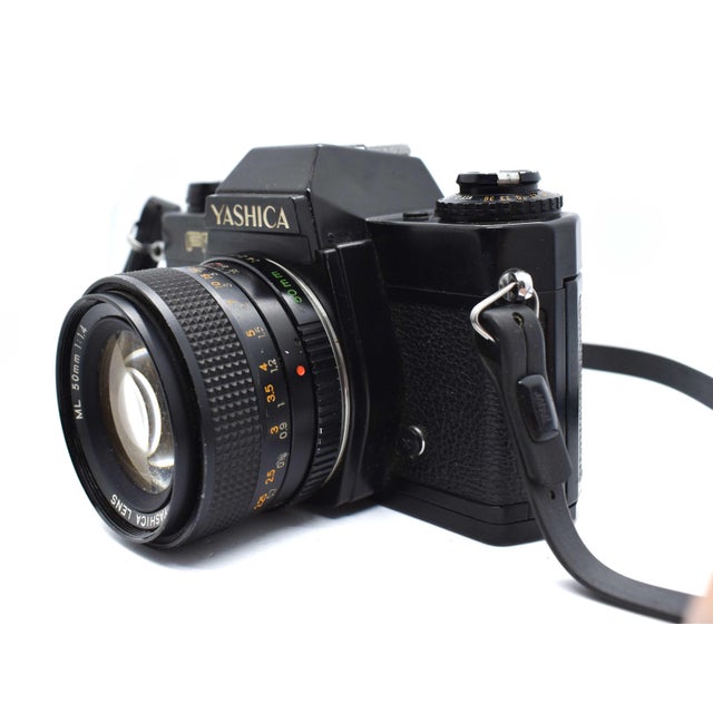 This classic Yashica FR 35mm film camera is a striking example of late 1970s precision engineering and sleek industrial...