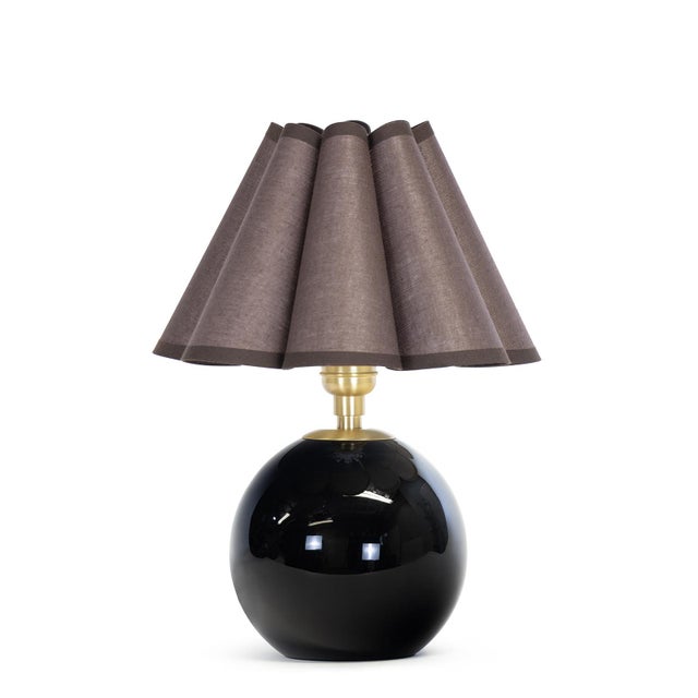Compact yet striking, the Giorgio Mini Table Lamp is anchored by hand-blown black glass. Designed for versatility, it...