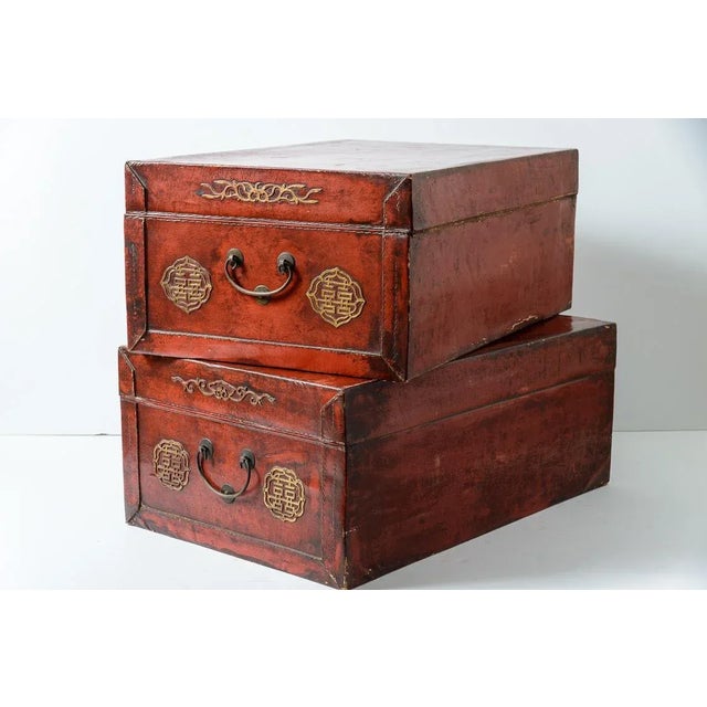 Great set of 2 large Chinese Red embossed leather trunks, the inside is also leather.. Beautiful poriginal patina through...