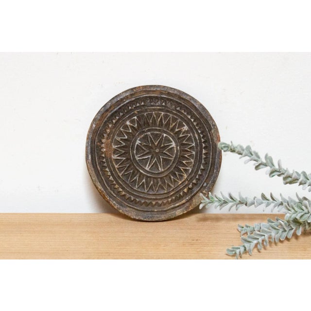 Vintage and primitive stone trivet plate, crafted from black stone with hand-carved tribal and geometric designs....