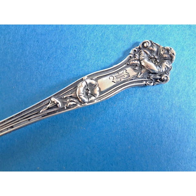 Offered is a beautiful 1909 art nouveau sterling silver teaspoon with deeply sculpted carving on both sides of the handle....