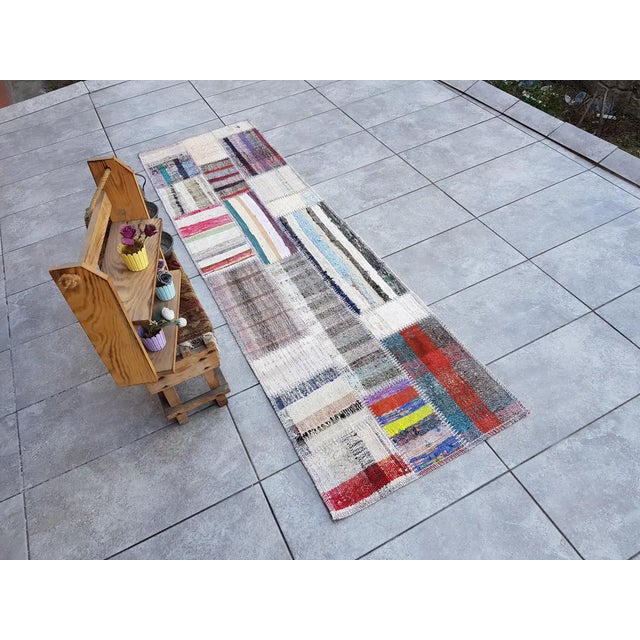 This is a vintage Turkish Oushak rug from the Mid 20th Century. The piece was hand-knotted.