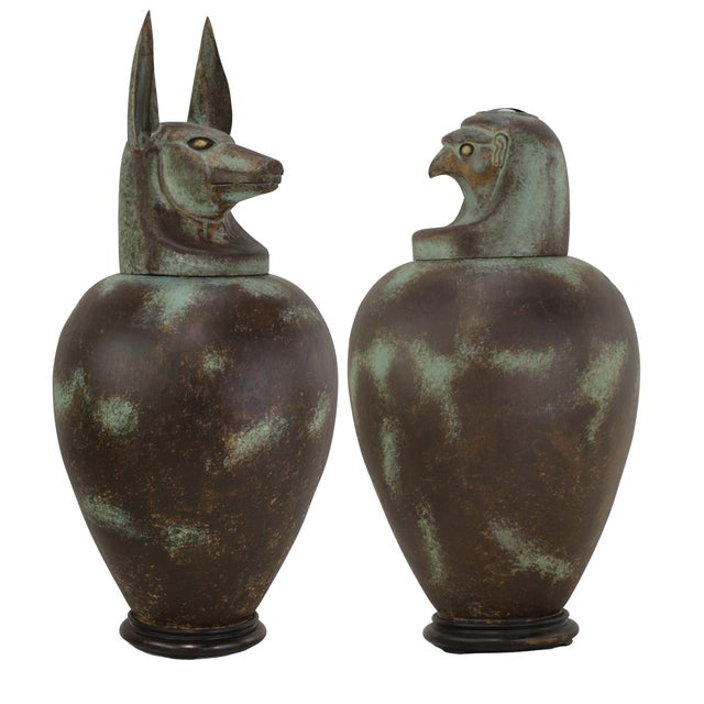 A pair of exquisite vintage hand-forged tin canopy jars. Duamutf (Jackal) and Kebekhsenuf (Falcon) A large-scale metal...