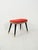 Vintage 1950s stool with a two-tone red velvet and gray fabric seat, turned black legs, and brass tips. The organically...
