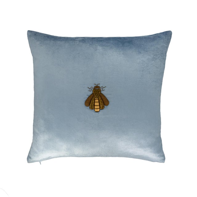 A refined decorative pillow cover crafted from luxurious cerulean silk velvet and adorned with an intricate gold bee...