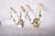 Matched pair of 1950s brass wall sconces attributed to Jules Leleu. Each has two scrolled brass arms extending from a...